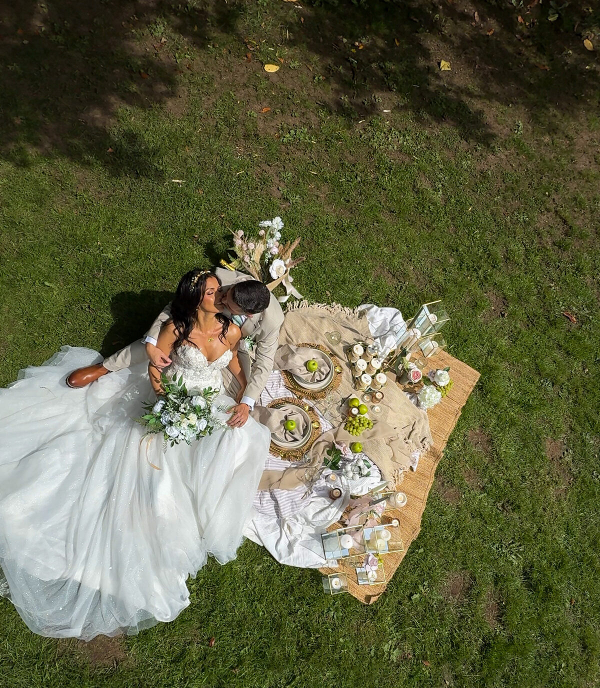 Bride and groom together at their wedding picnic setup