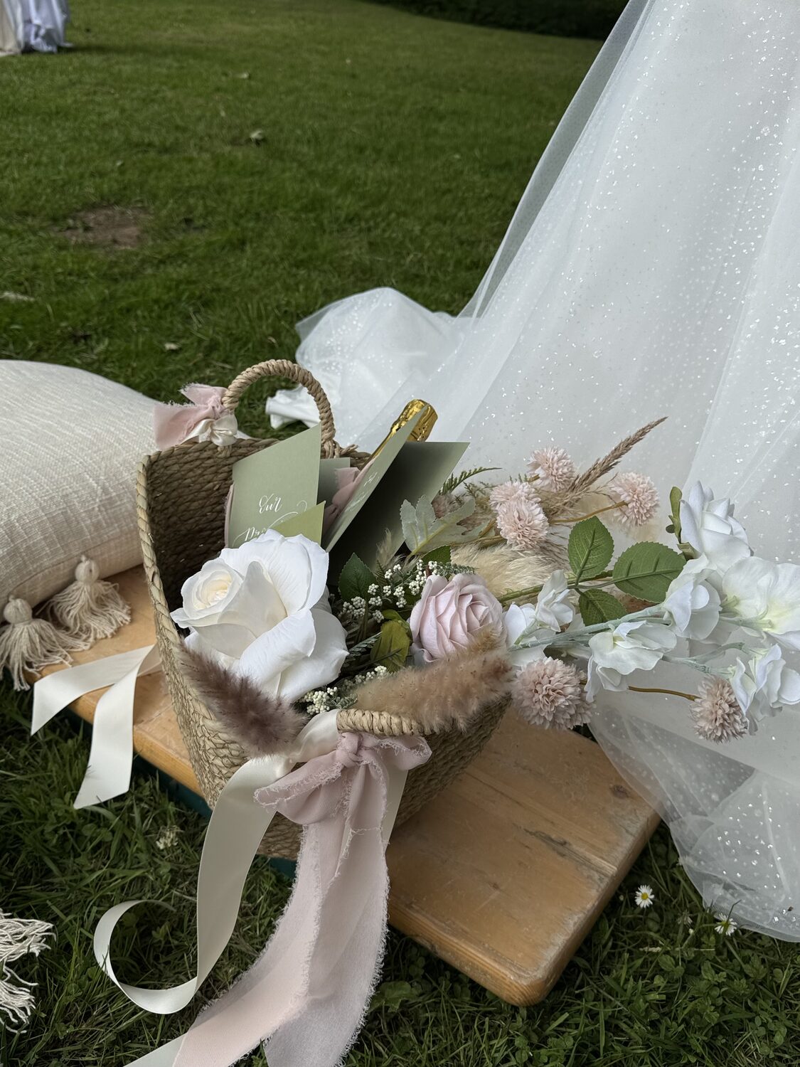 Flower basket beside the bride's wedding dress